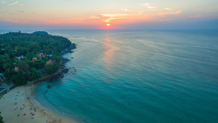 aerial view the sun going down to holison at Karon beach Phuket two jet boats sail in Karon sea during sunset .