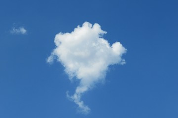 Beautiful round fluffy cloud in the middle of the blue sky, natural background