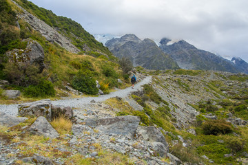 Summertime view of Backpacker a walking at mount cook national park , South island New Zealand