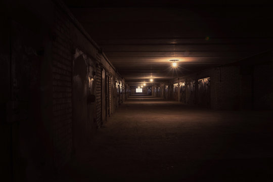 Dark long hallway with metal gates