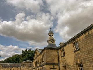 Stables roof top with clock tower England UK