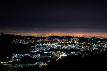 City at night over the hill