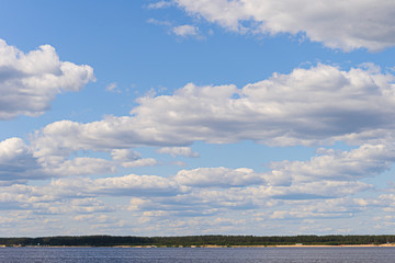 Volga river landscape with a distant wooded shore and sky with clouds