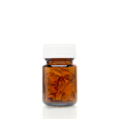 pills of fish oil capsule in glass bottle
