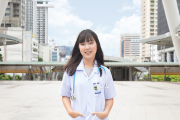 The woman Asian doctor  White Shirt suit with stethoscope working outdoor Hospital.