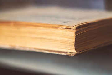 An old open book, a photo from a corner of a close-up.
