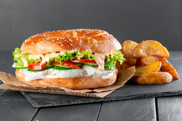 Hamburger with fries on a slate plate