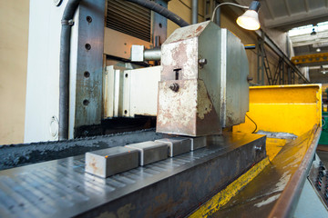 Processing of rectangular parts on a flat grinding machine, wide-angle photo.