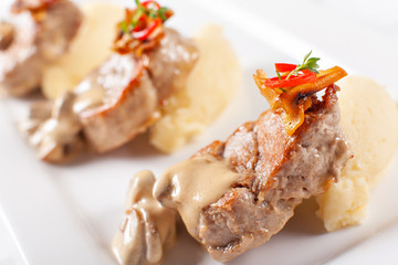 Pork Medallions with Mashed Potato and Mushrooms. Pork tenderloin on a white plate, good serving. restaurant menu