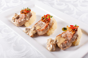 Pork Medallions with Mashed Potato and Mushrooms. Pork tenderloin on a white plate, good serving. restaurant menu