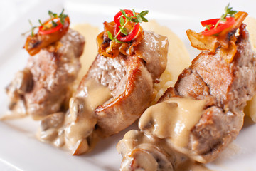 Pork Medallions with Mashed Potato and Mushrooms. Pork tenderloin on a white plate, good serving. restaurant menu