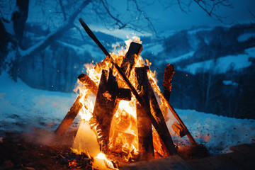 Winter campfire in the top of the mountains at the evening.