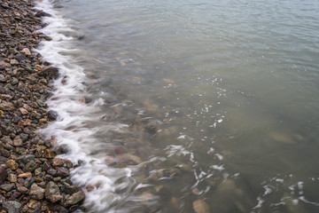 high angle view of the Sea waves splash on stones.