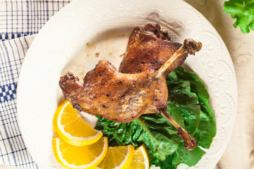 Duck legs confit with orange and salad
