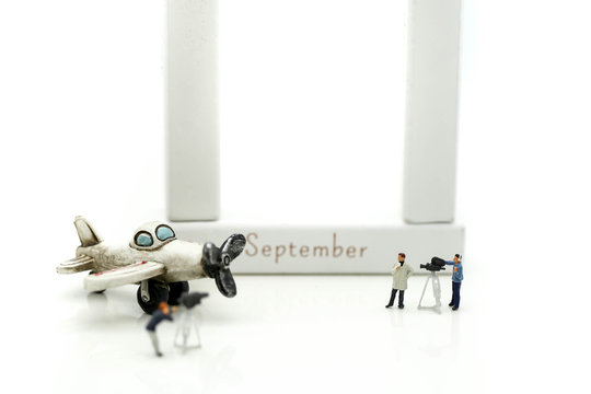 Miniature people : journalists , cameraman ,Videographer at work shooting of airplane with toy building using for concept Patriot Day