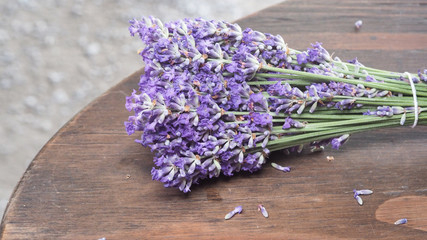 Lavender flower close up and blooming put on the wood table. It give relax herb smell.