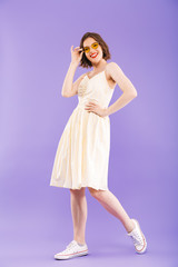 Full length portrait of a smiling young woman