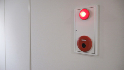 Blerry image of Emergency Fire alarm or alert or bell warning equipment red color on white background wall in the building for safty in japan