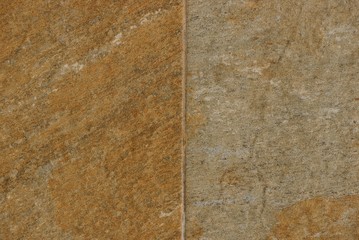 brown gray stone texture from an old wall on the facade of a building