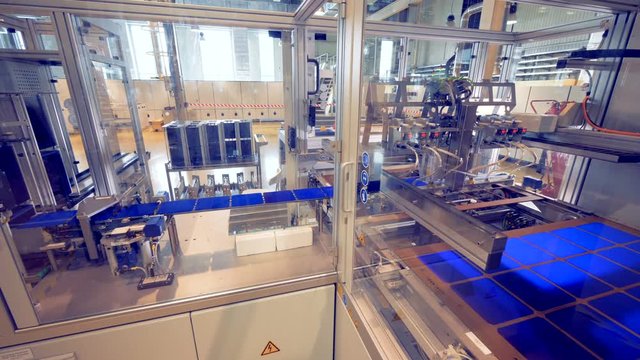 Factory equipment assembles solar modules.