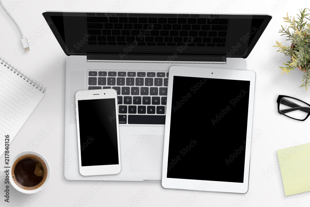 Aufkleber Smart phone and tablet mockup on laptop keyboard. Office desk concept. Top view.