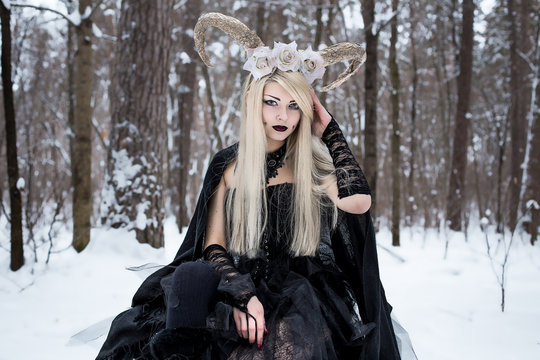 Pretty goth girl walk in snowy forest. Cosplay horny fairy