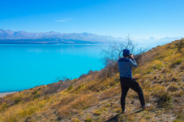 Photographer taking a photo Aoraki Mt cook national park, South Island New Zealand 