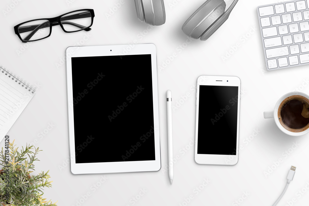 Poster Tablet and phone on office desk. Blank screen for mockup, app or responsive web site presentation. Flat lay.
