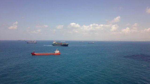 Various types of cargo ships including a container ship, at sea - Aerial footage 