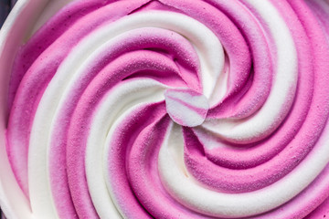 Swirling pink Italian ice cream with a ridged pattern background texture
