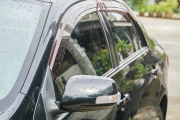 Fototapeta premium close up wing mirror with LED light bar of black car
