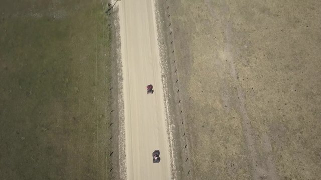 Aerial Drone View Tracking ATVs on Dirt Road Directly Above