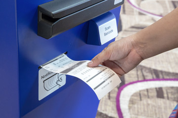 hand holding checking a bill receipt use automatic barcode scanner