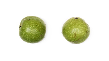 Green walnuts isolated on white background, top view