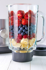 Making smoothie , fresh fruits in glass blender jar - 217845540