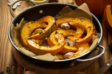 Baked pumpkin with thyme, olive oil and garlic, delicious autumn dish.