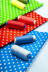 Fototapeta na wymiar Sewing accessories and multi-colored fabrics