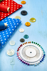 Fototapeta na wymiar Sewing accessories and multi-colored fabrics