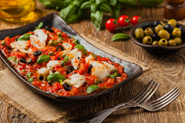 Cod in Italian in tomatoes with olives and capers.