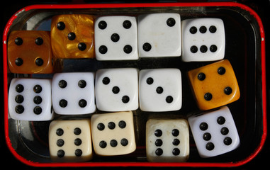 Many dices in a metal box. Game of chances. Golden dice. 