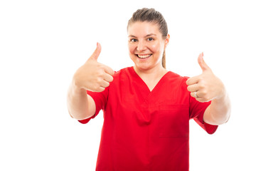 Medical nurse wearing red scrub showing double thumb up gesture.