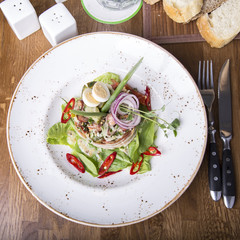 Munich salad. Bavarian salad with  pieces of fried sausage and bacon. Top view