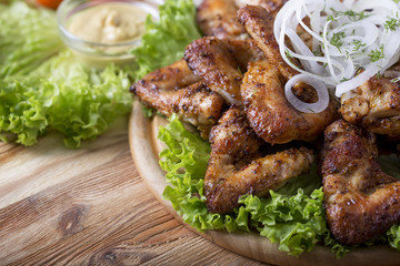 Grilled chicken wings on wooden board. Tasty bbq chicken wings