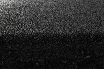 Close-up on a layer of new asphalt at the road under construction.