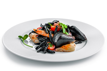 High class healthy Italian seafood pasta meal isolated on white background.. Black squid ink strozzaperti with shrimp and mussels on a plate.