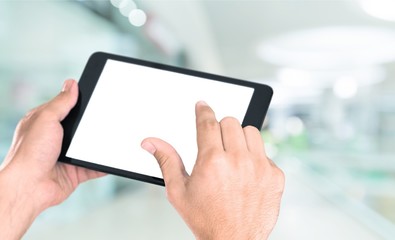 Fototapeta na wymiar Hands holding digital tablet, close-up view