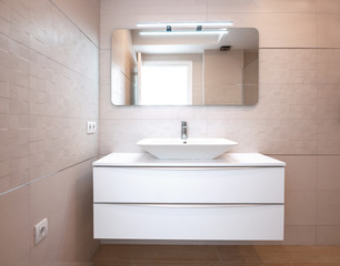  Modern design in the bathroom. Luxury white porcelain sink on a bathroom table.