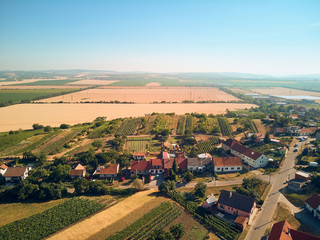 Fototapeta na wymiar Aerial view of landscape with houses roofs and fields, Czech Republic