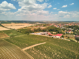 Aerial view of houses and fields against blue sky with clouds, Czech Republic