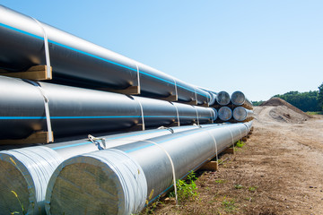 storage place of big plastic pipes for  heating, plimbing, sewage on a building site
